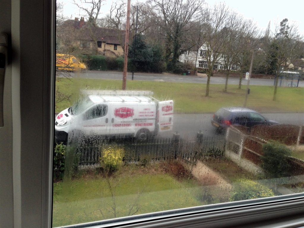 The Steamy Windows van on a Doncaster street, barely visible through a misted up, condensation covered window pane