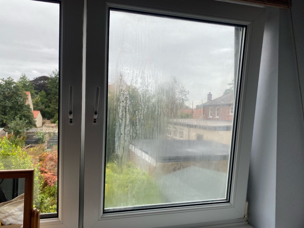 Before: heavy condensation trapped between the panes of a failed uPVC double glazed unit in a Doncaster home